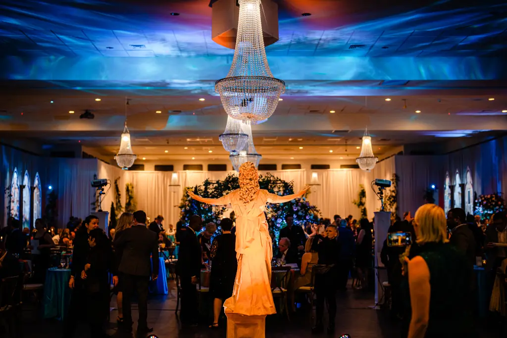 Party with blue and purple lights on the ceiling.
